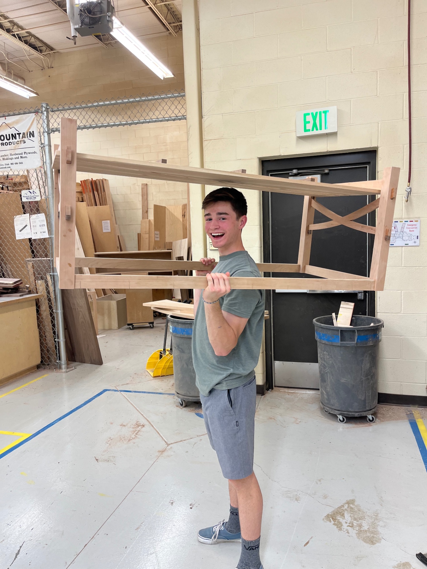Phillip in the woodshop with a handmade table